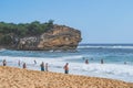 View of Shipwreck beach as Tourists enjoy the pacific ocean in Poipu. Royalty Free Stock Photo