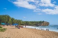 View of Shipwreck beach as Tourists enjoy the pacific ocean in Poipu. Royalty Free Stock Photo