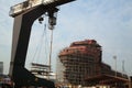 View of shipyard with straddle crane and ship under construction