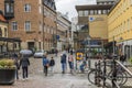 View of shopping street with shops and people in downtown of Uppsala.