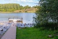 View of a forest lake with ducks and a boat dock. Royalty Free Stock Photo