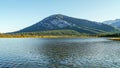 View from the shore of a lake with mountain and forest in the distance