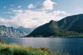 View from the shore to the sea against the backdrop of a forested mountain range Royalty Free Stock Photo