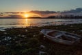 View of shore of Trasimeno lake with a little boat at sunset