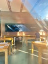 View from the showcase at Empty tables of Apple Store with no customers inside