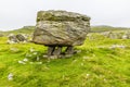 A view showing a glacial erratic supported on the limestone pavement on the southern slopes of Ingleborough, Yorkshire, UK Royalty Free Stock Photo