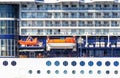 View of the side deck of a large cruise ship, Windows balconies chairs tables, lifeboat, texture in the form of building wall Royalty Free Stock Photo