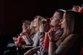 Group watching intriguing movie in cinema. Royalty Free Stock Photo