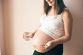 View from side of pregnant woman taking vitamins Royalty Free Stock Photo
