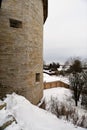 View from the side of the old fortress tower on the village and the surrounding winter landscape in Russia.