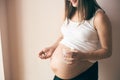 View from side of pregnant woman taking vitamins Royalty Free Stock Photo