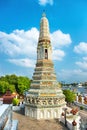 View of side tower of Wat Arun on blue sky background