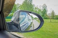 A view in the side view mirror. Mirror rear car. Reflection of t Royalty Free Stock Photo