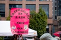 View of sign Experiment in labs not on Schools taken during Vancouver rally for mandatory masks in schools outside the Vancouver