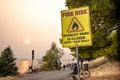 View of sign Fire Risk, Stanley Park is Closed on Second Beach. Smokey Sky over Vancouver from wildfires