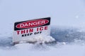 View of sign on a frozen Lost Lagoon lake in Vancouver. `Danger, Thin Ice, Keep off`. Royalty Free Stock Photo