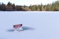 View of sign on a frozen Lost Lagoon lake in Vancouver. `Danger, Thin Ice, Keep off`. Royalty Free Stock Photo