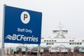 View of Sign Staff only on a Parking Lot at BC Ferries Little River Terminal with a ferry in the background