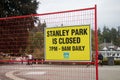 View of sign Stanley Park is Closed from 7pm to 9am daily following attacks by coyotes in Stanley Park