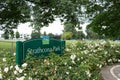 View of sign `Strathcona Park` in downtown Vancouver with tent city full of homeless people in the background