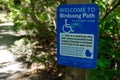 View of sign Welcome to birdsong path on Juniper Loop inside the Lighthouse Park in West Vancouver