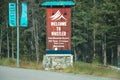 View of sign Welcome to Whistler with forest in the background. Vintage look