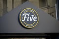 view on the signboard of the firm five which is pizzeria sign