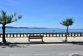 View of Silgar Beach from promenade with stone handrail and wooden bench. Rias Baixas, Pontevedra Province. Sanxenxo, Spain. Royalty Free Stock Photo