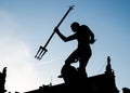 Silhouette of Neptune`s fountain against contrails in the sky, Dlugi Targ or Long Market street, Gdansk, Poland