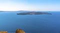 A view from Skaros Rock, Santorini towards the volcanic island of Nea Kameni Royalty Free Stock Photo