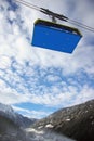 A view of the ski cable car against blue cloudy sky from the valley