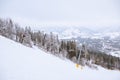 view of ski resort lift mountains in fog