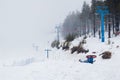 A view from the skiing slope in Dragobrat, Ukraine. View of the chairlift in the fog