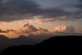 view of sky with big colorful clouds over mountain silhouette. Beauty in nature.