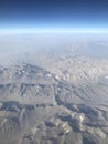 A view from the sky on the Earth. Mountains, sky, nature and landscape from a plane window Royalty Free Stock Photo