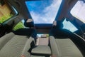 View of the sky from the open roof of the car.