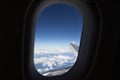 View of sky, plane window, part of wing and engine Royalty Free Stock Photo