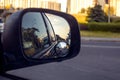 view of the sky in the right side car mirror in the evening at sunset. Royalty Free Stock Photo