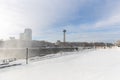 View of the skyline of the Canadian side of the falls across an iced over winter wonderland viewing platform Royalty Free Stock Photo