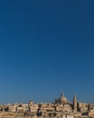 Skyline of Valletta, Malta under blue sky, with dome of Basilica of Our Lady of Mount Carmel and tower of St Paul`s Pro-Cathedral