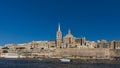 Skyline of Valletta, Malta under blue sky, with dome of Basilica of Our Lady of Mount Carmel and tower of St Paul`s Pro-Cathedral