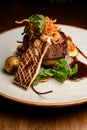 view of slice of grilled king oyster mushroom and piece of fried meat with potatoes