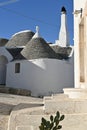 View of a small alley with trulli houses in Alberobello, Apulia - Italy