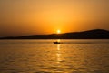 View of a small boat, Aegean sea and landscape at sunset captured in Ayvalik area of Turkey