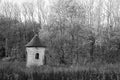 View of a small chapel in a forest in grayscale in Plancenoit, Belgium