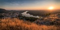 View of Small City with River from the Hill at Sunset Royalty Free Stock Photo