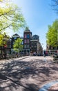 View of a small city square and a bridge over the Amstel canal in Amsterdam, Netherlands Royalty Free Stock Photo