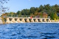 View of a small dam along a river on a clear autumn day Royalty Free Stock Photo