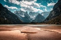 View of small emerald green mountain lake in Dolomites, Italy, in which Mount Latemar are reflected Royalty Free Stock Photo