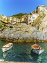 A view of small fishing boats moored in front of the village of Manarola, Cinque Terre, Italy Royalty Free Stock Photo